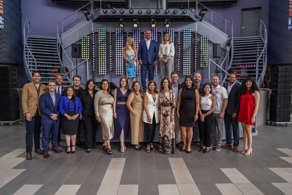 Photo of the Invest Puerto Rico team, with InvestPR CEO Ella Woger-Nieves, Governor Pedro Pierluisi, and InvestPR CMO Nicole Villalte standing at the back.